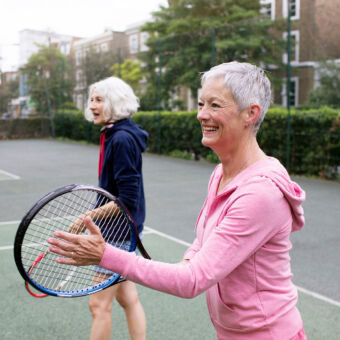 Two women playing tennis together