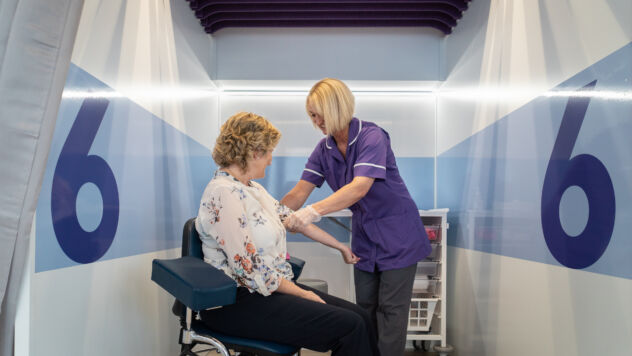 Trial nurse taking blood from participant