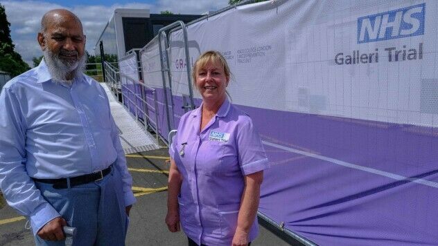 Participant and trial nurse outside an NHS-Galleri trial mobile clinic